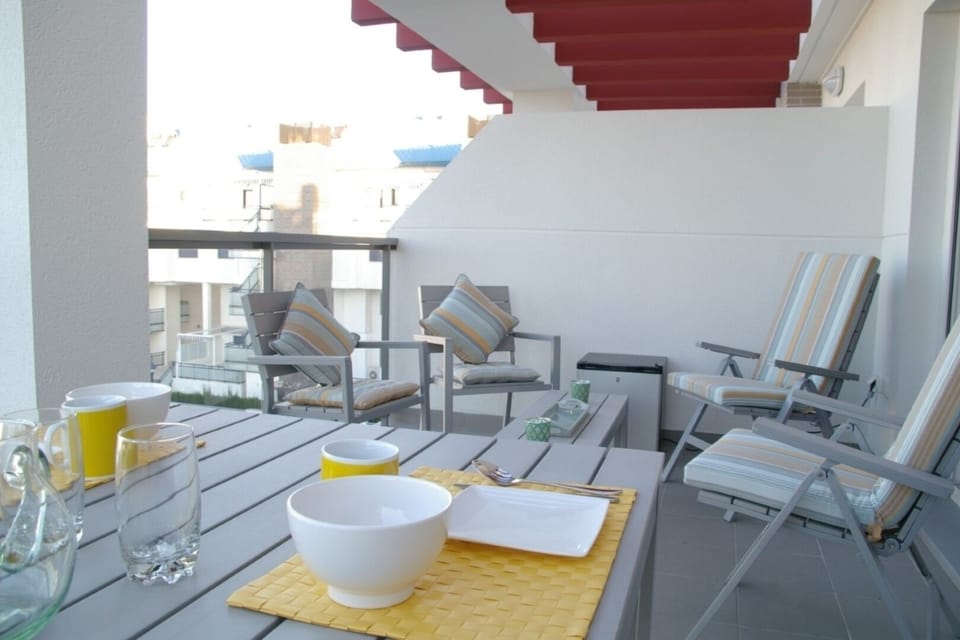 Balcony with seating and dining area.