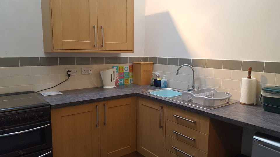 Newly fitted kitchen with table and chairs seating 6 people