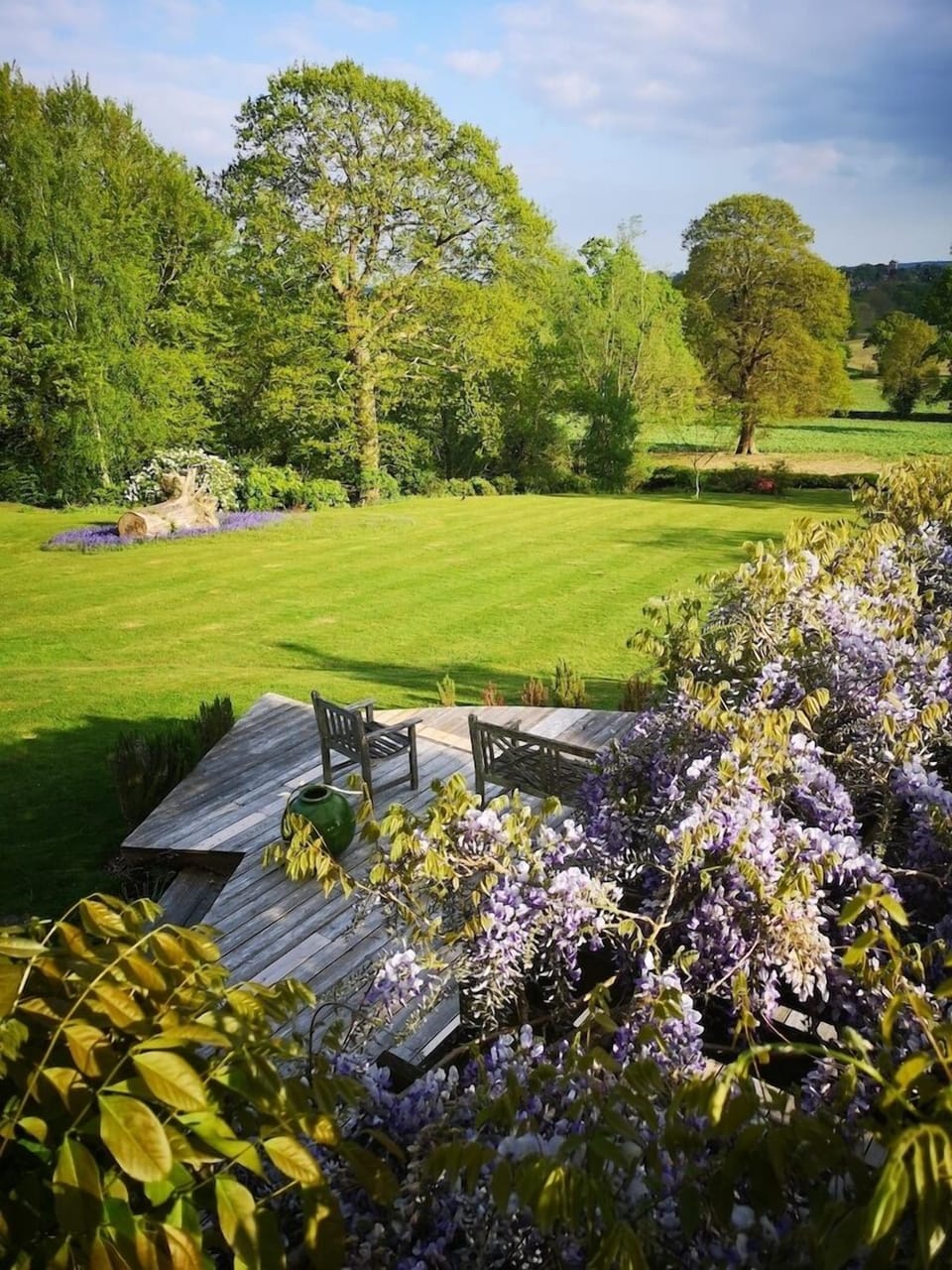 View from the master bedroom across the deck and wisteria-covered dining pergola