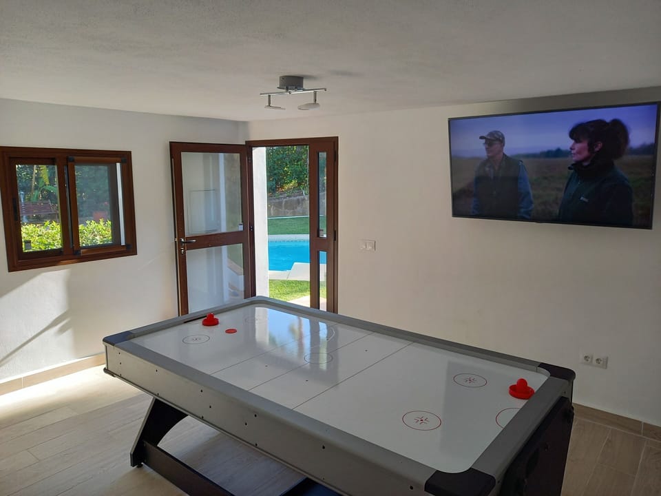 Games room - air hockey table and TV. Looking out.