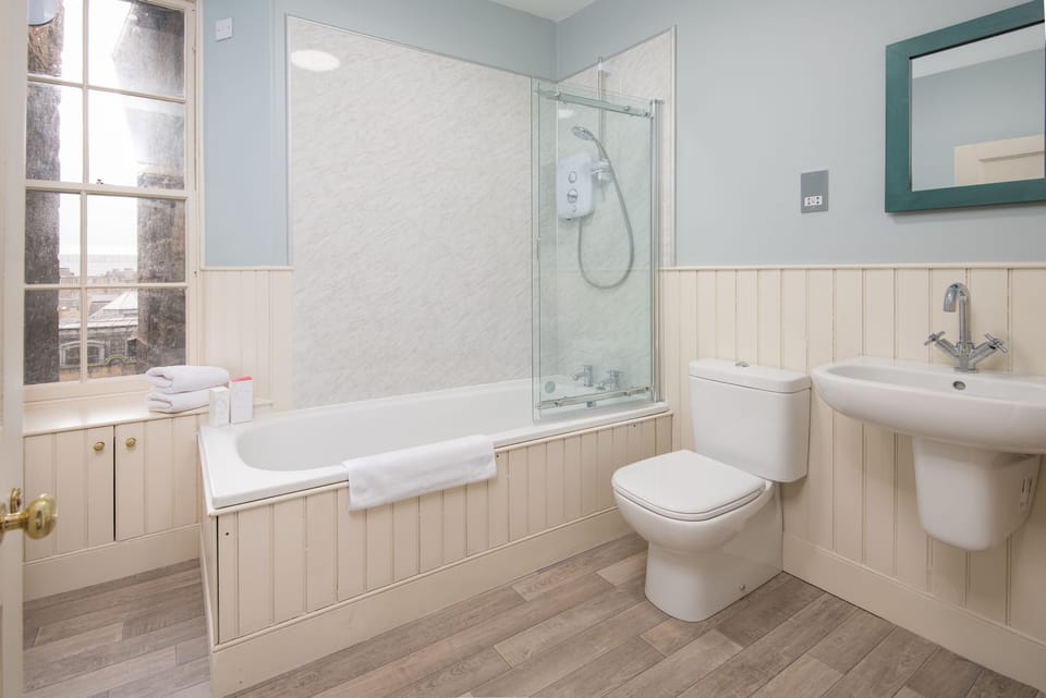 Spacious family bathroom with bath and shower