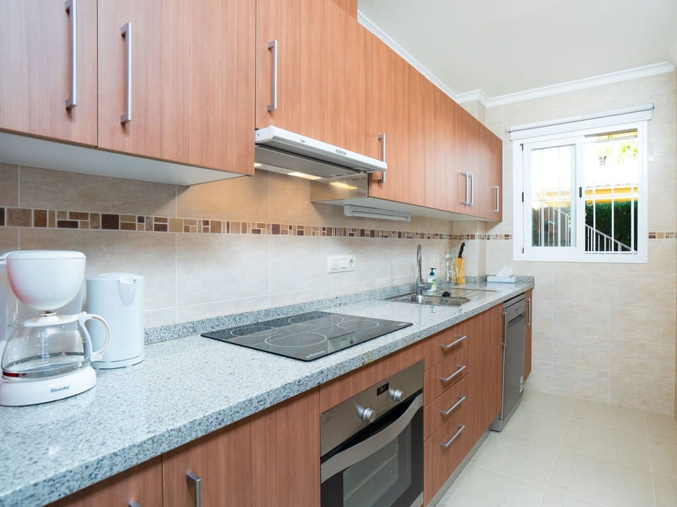 Countertop, Property, Kitchen, Cabinetry, Room, Furniture, Interior Design, House, Kitchen Stove, Building
