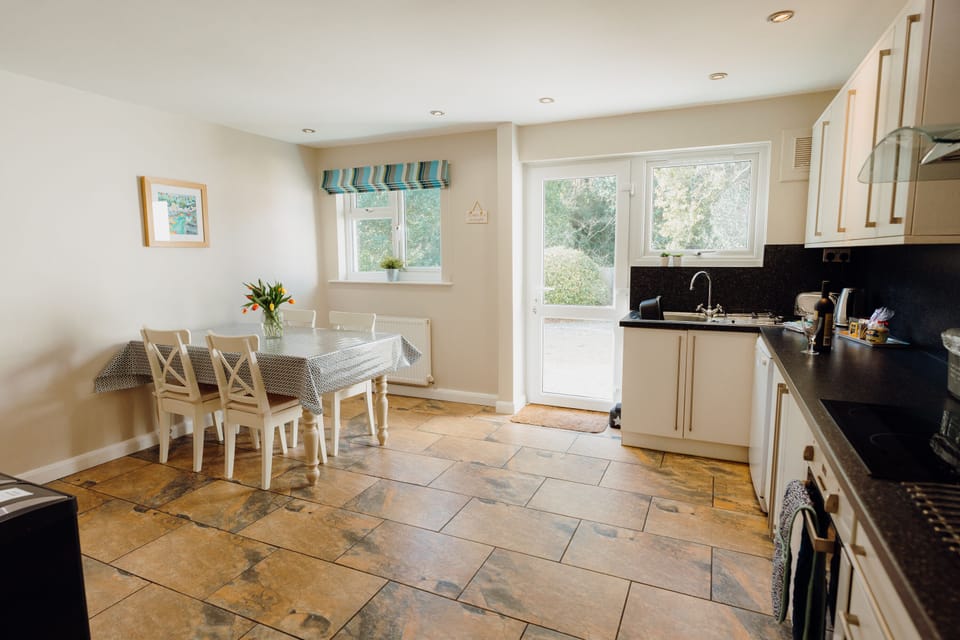 The back of the house looks over woodland