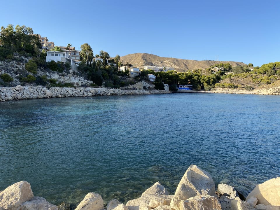 from the point looking over the lagoon-like water to the gravel beach & harbour