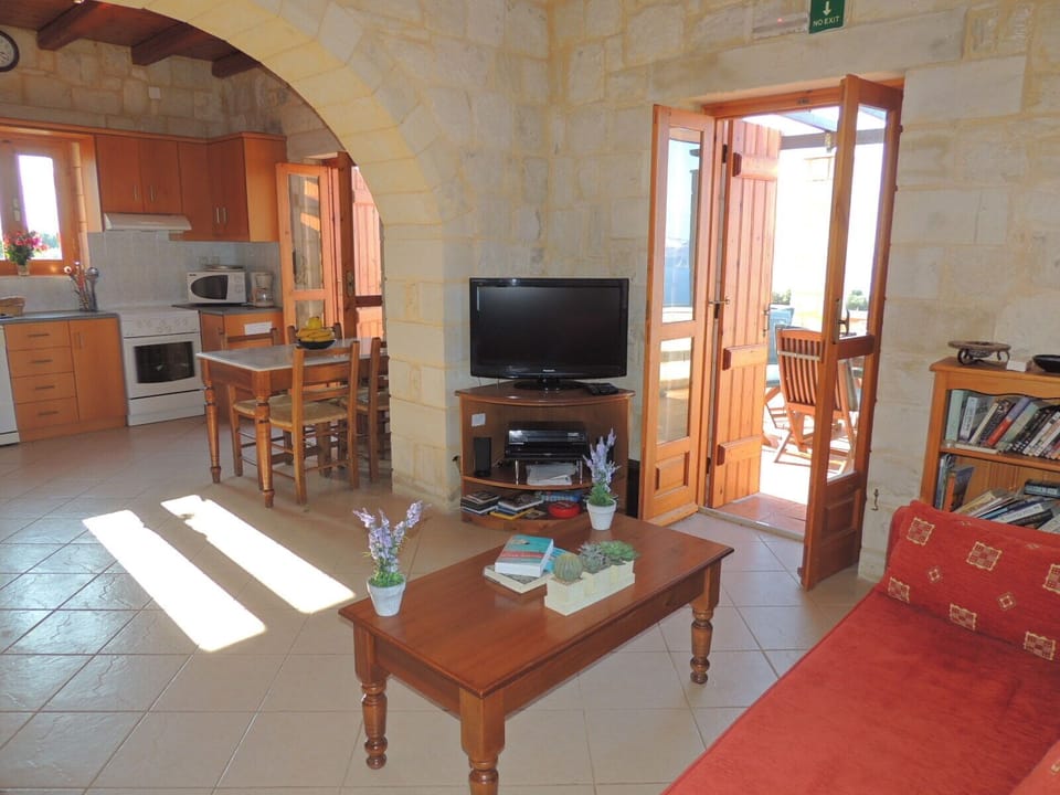 Chrisi Villa upstairs living room with arch to kitchen