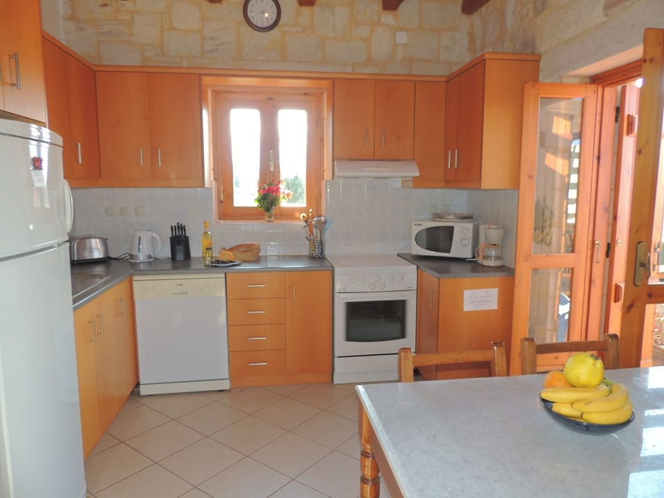 Chrisi Villa modern kitchen and inside dining area