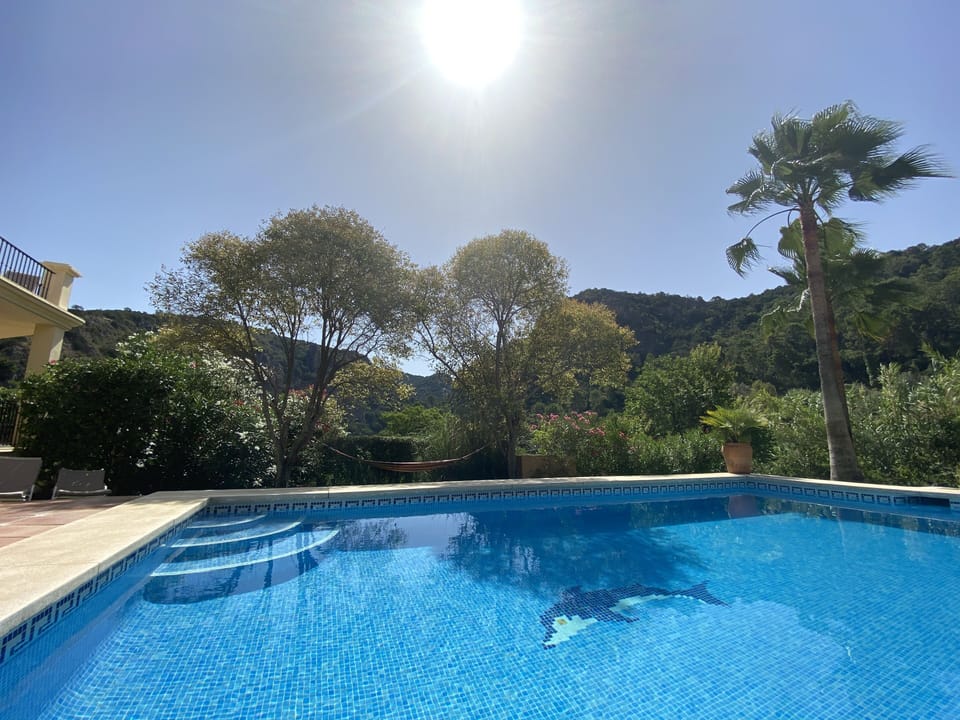 Private heated pool with lots of pool toys, right by the house and seating area