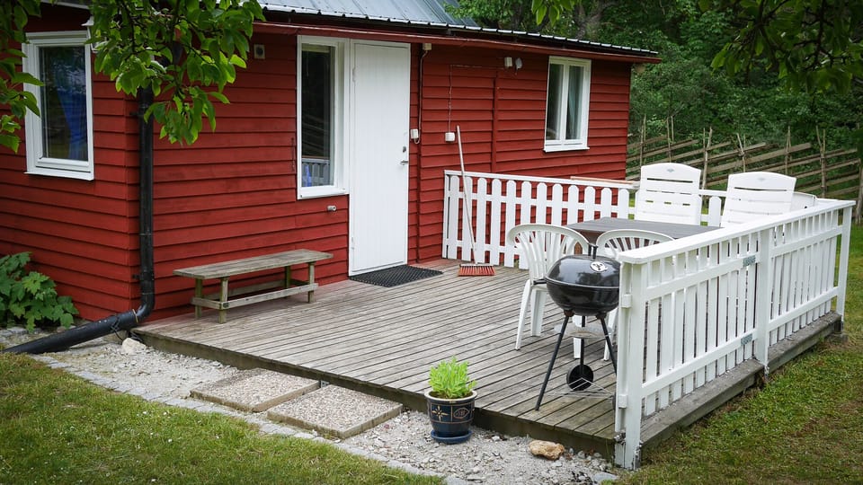 The porch and outdoor seating area of the cabin