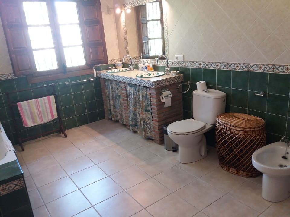 Large family bathroom, double washbasin, bath and shower above, wc and bidet