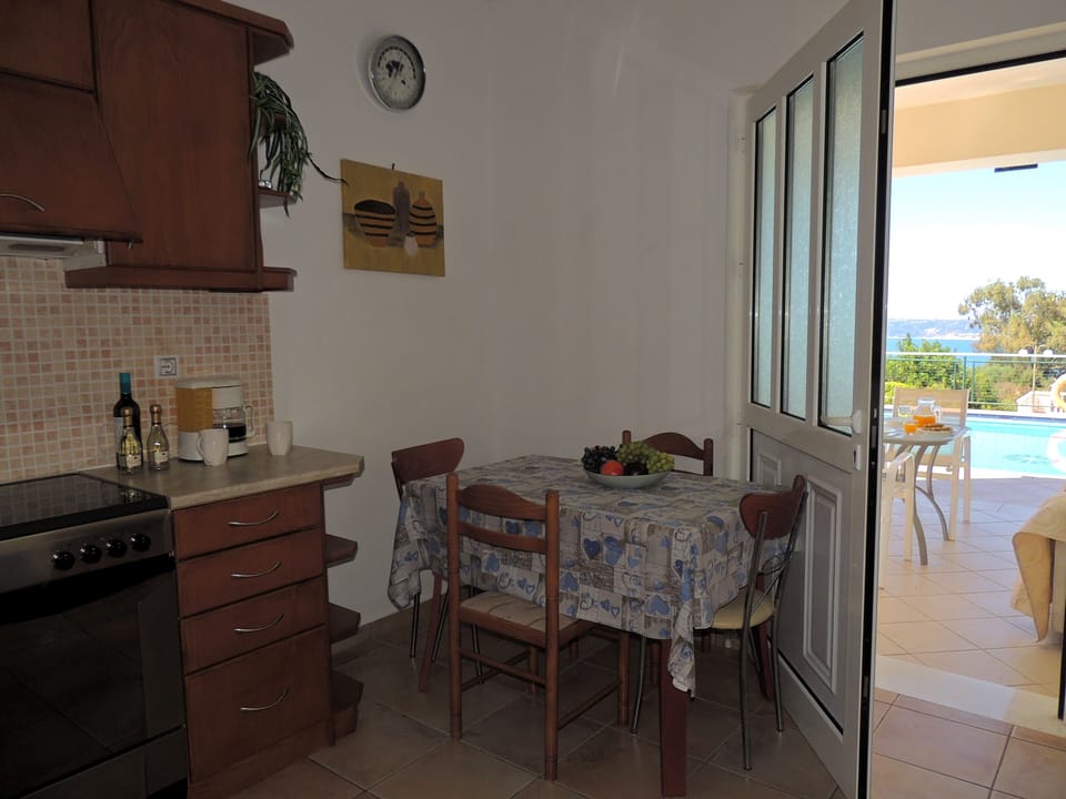 11 Nostalgia kitchen with door to outside shaded dining area.
