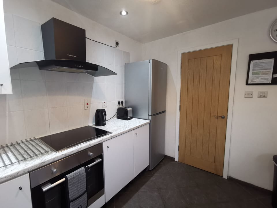 Photo of the kitchen taken from a different angle. Door to separate dining room.