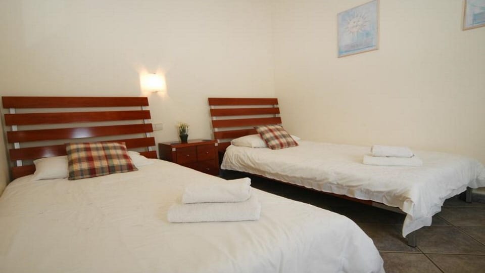 Twin room with ceiling fan and fitted wardrobes