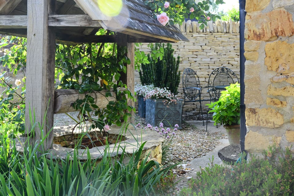 View of Well surrounded by Iris' in the spring looking toward the seating area.