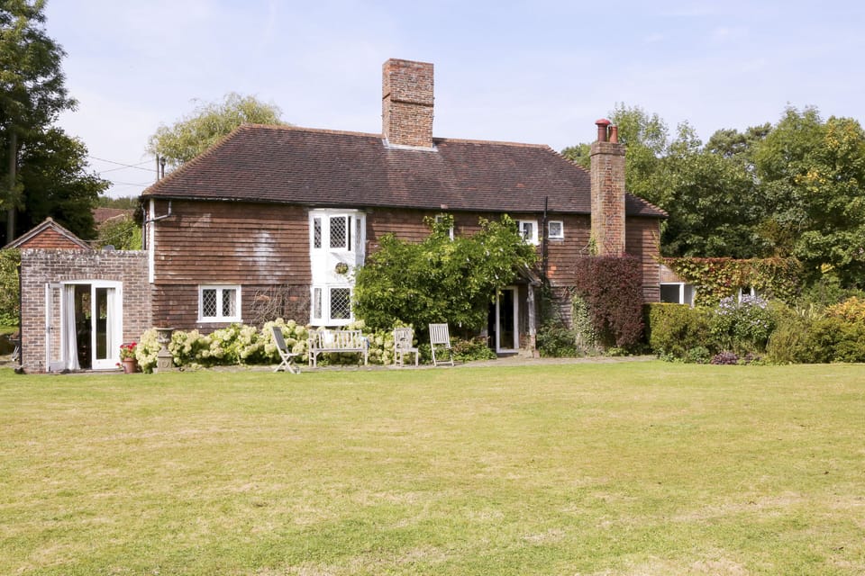 Back of house with first lawn
