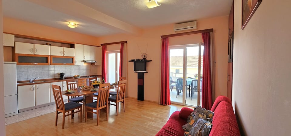 Open plan living/dining/kitchen area opening into sea view terrace