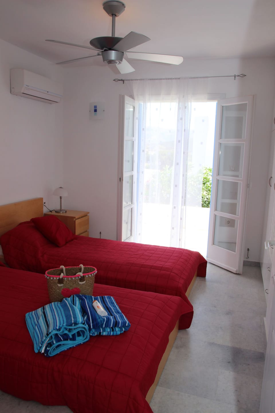 Twin bedroom with patio doors opening on to the ground floor terrace
