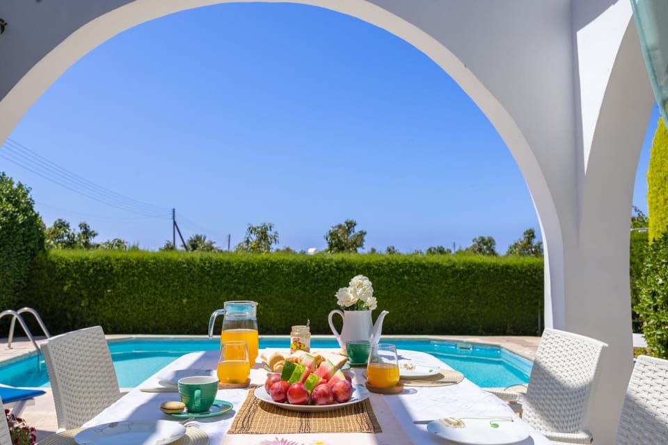 Dine on the charming breakfast terrace next to the pool