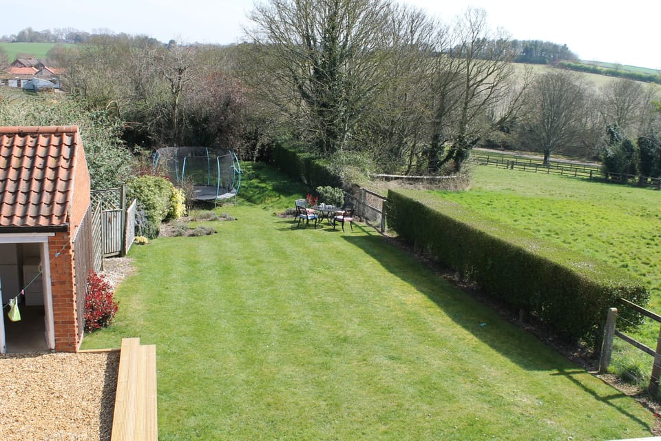 Large backgarden with additional seating and trampoline.