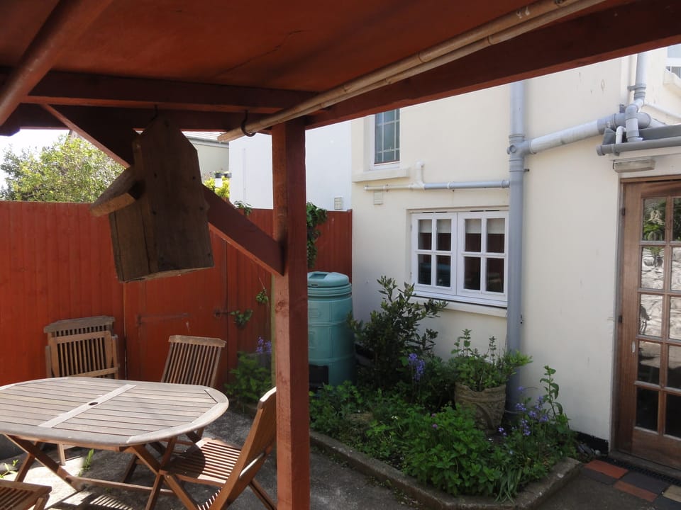 Patio table, chairs, bbq, log store, composter, bins.