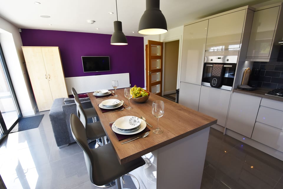 Kitchen with 4 Bluetooth Speakers and Bi-folding doors.