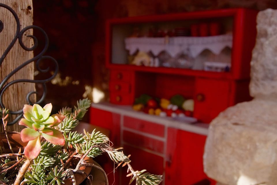 Red kitchen cupboard under the porch