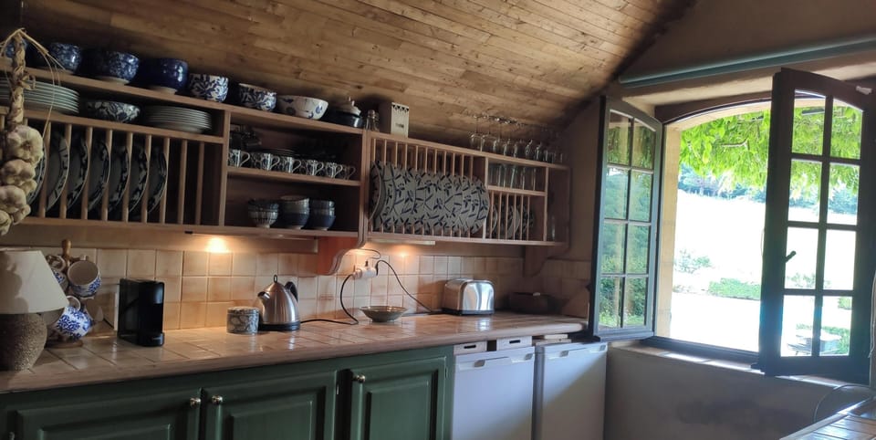 Kitchen looking over the terrace and swimming pool 