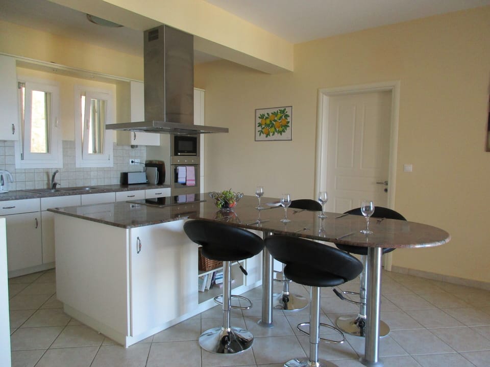 Fully fitted kitchen with island unit and breakfast bar