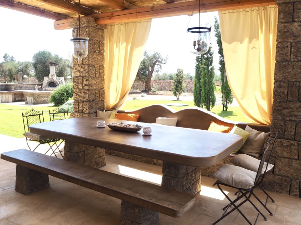 Outdoor dining area, under the patio and overlooking garden and pool