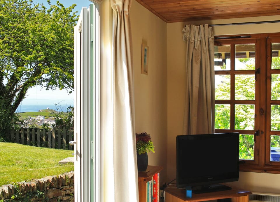 Lounge & view to outside, cliffs & sea in the background
