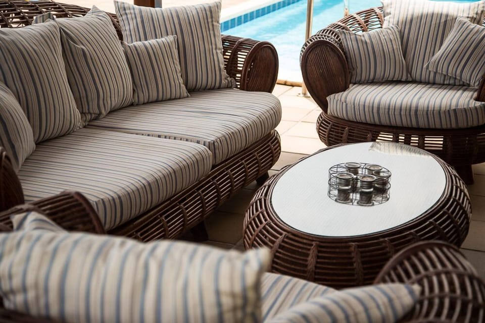 Cane furniture underneath a pergola