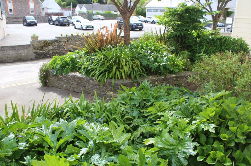 Public garden area opposite the Old Shop apartment with seating area.