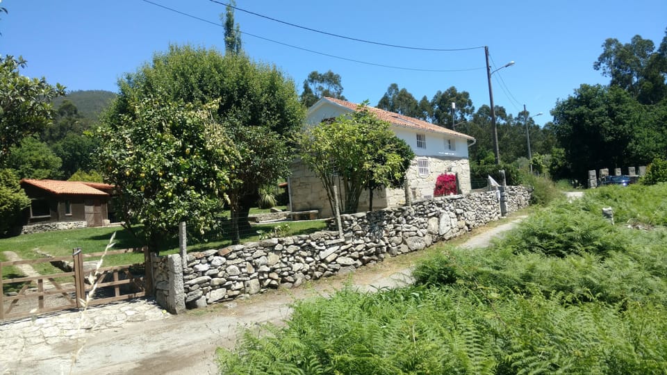 The house sits in a large garden on a quiet country lane