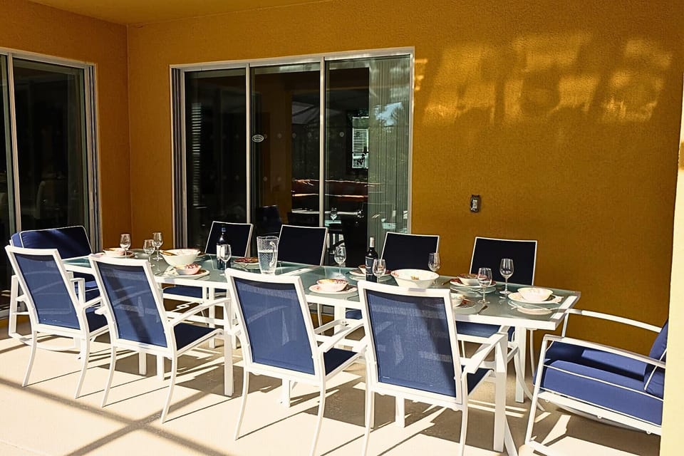 Enjoy al fresco dining under the canopy and overlooking the pool.