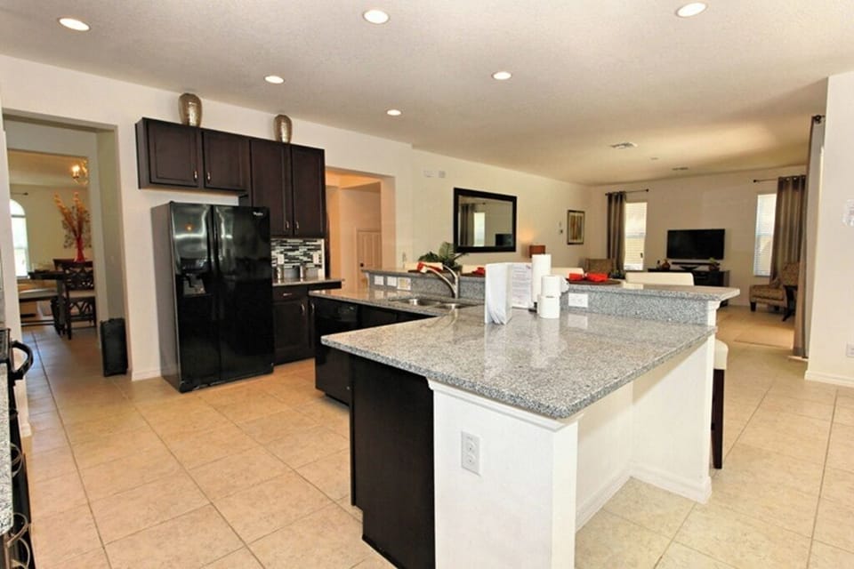 Open plan kitchen with wide range of modern appliances including Ninja Air Fryer