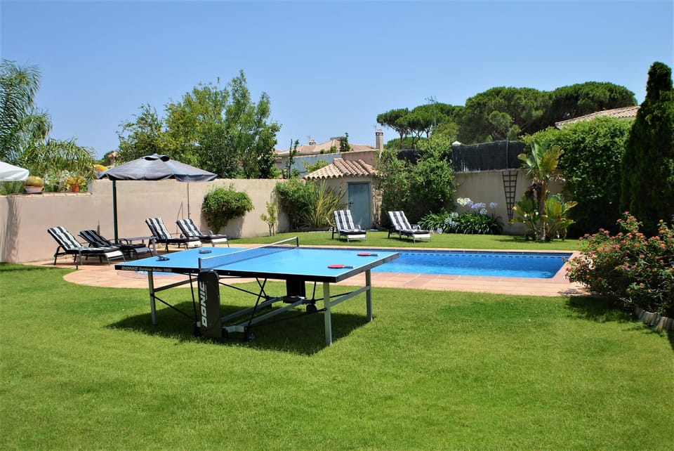 have some fun playing table tennis beside the pool