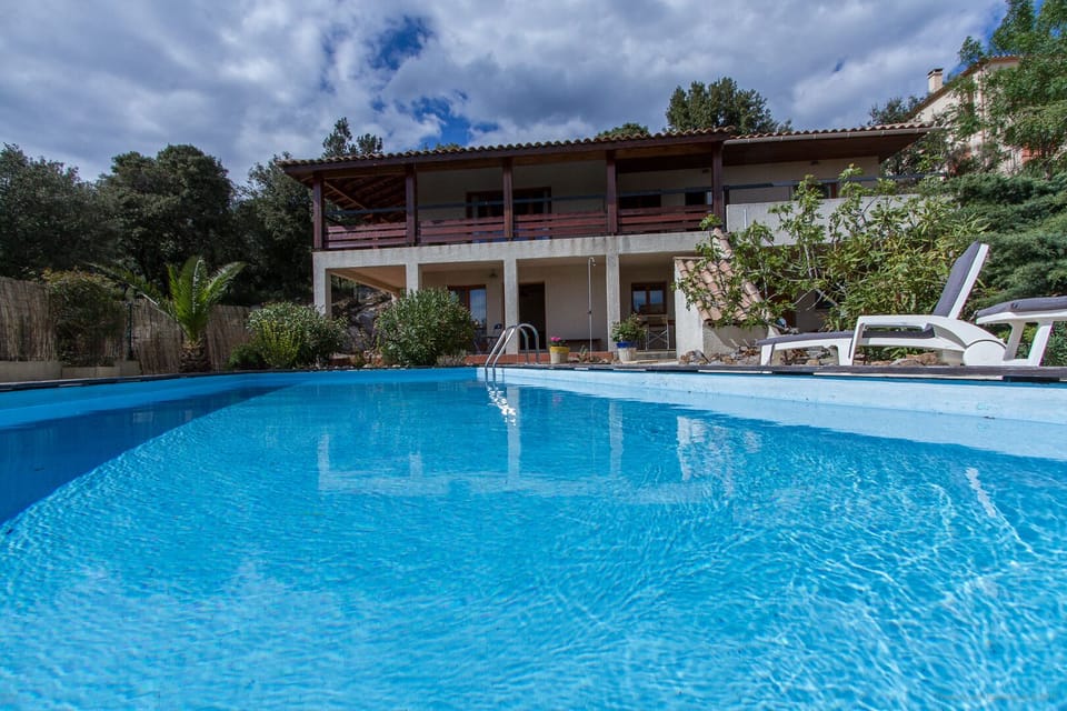Luxury villa with view from the pool in idyllic setting