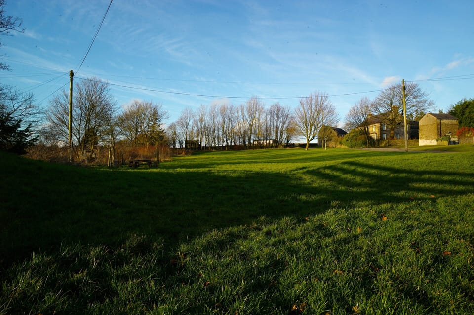 Recreation ground behind, open countryside beyond