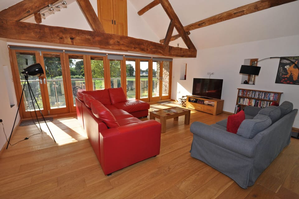 The comfortable seating area looks towards the balcony & the garden