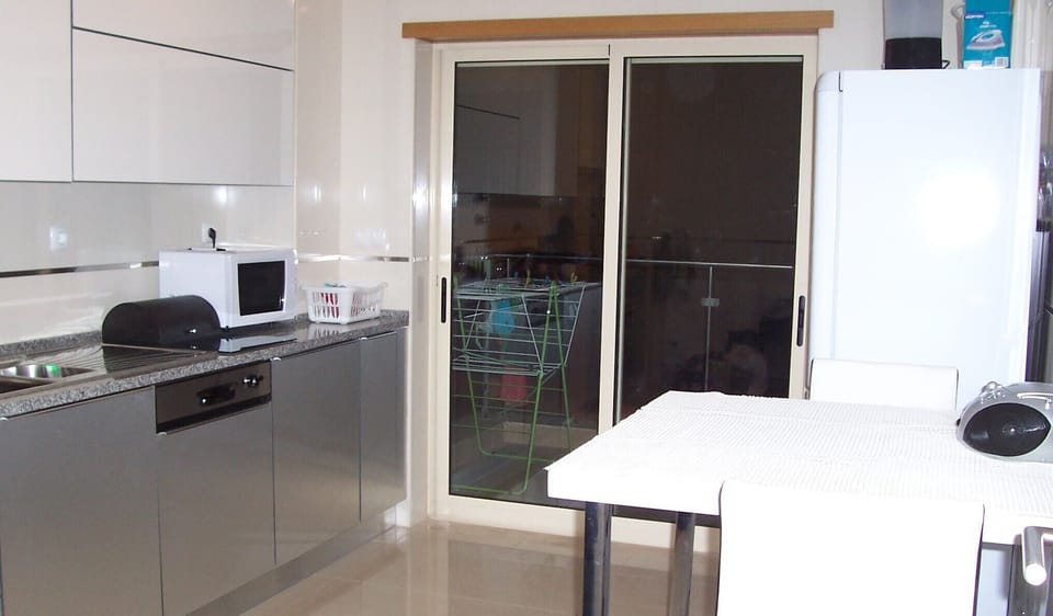 THE KITCHEN WITH PATIO DOOR TO THE BALCONY