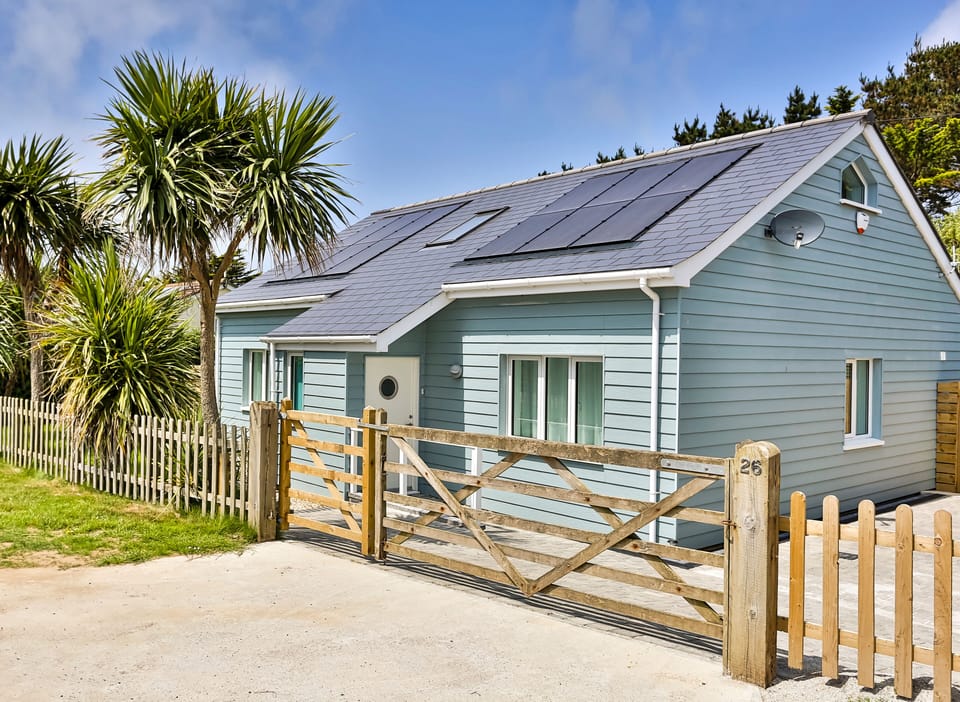 Front of Endless Summer with gated drive and parking for 2-3 cars