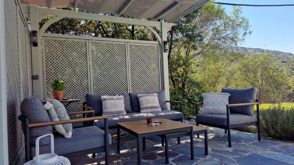 a pergola shaded lounge with panoramic mountain views,