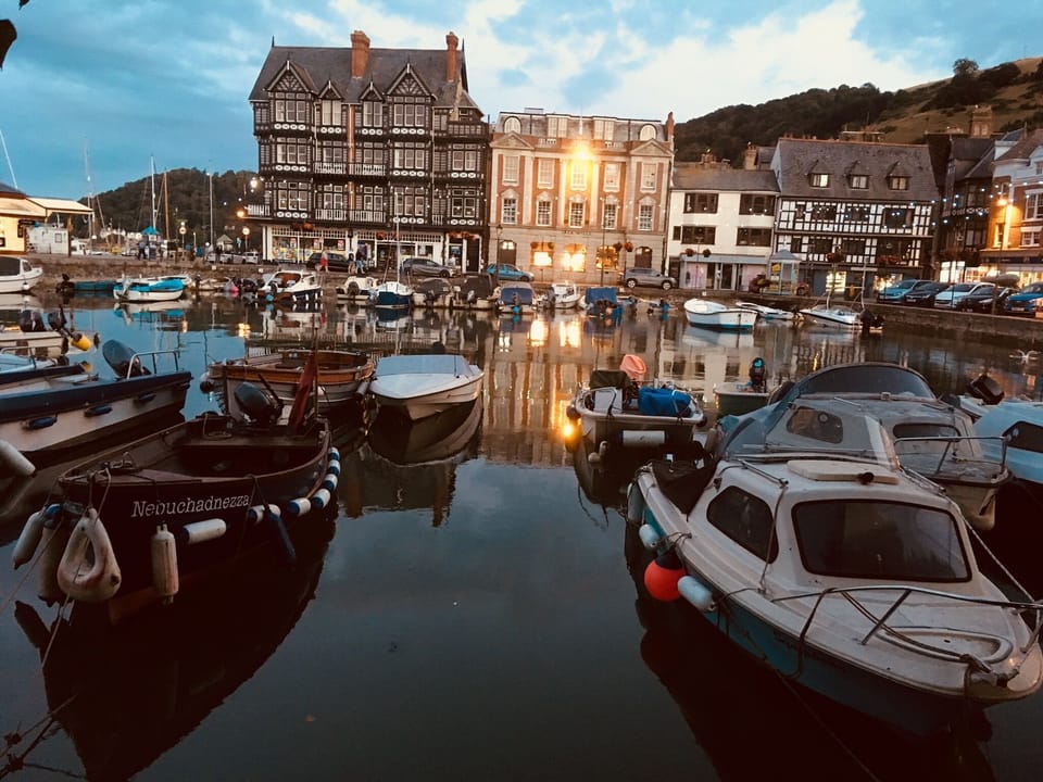 Dartmouth boat float with sun setting