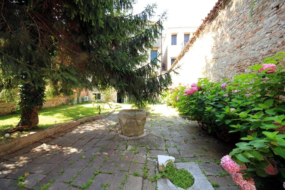 Garden of the building with the original wellhead