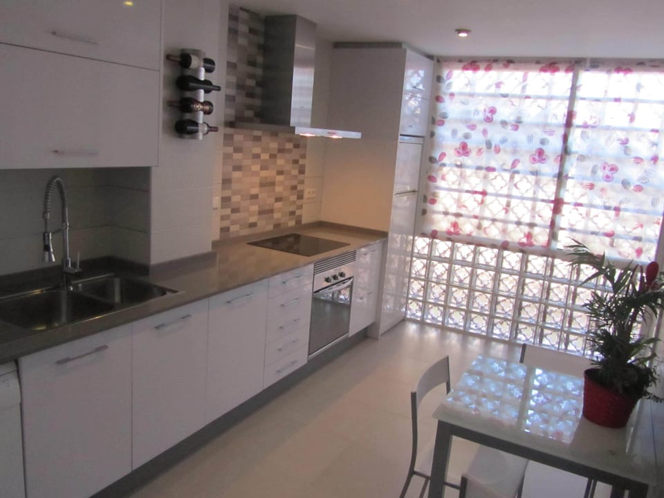 Very large kitchen with sea views, modern appliances,seating area & large larde
