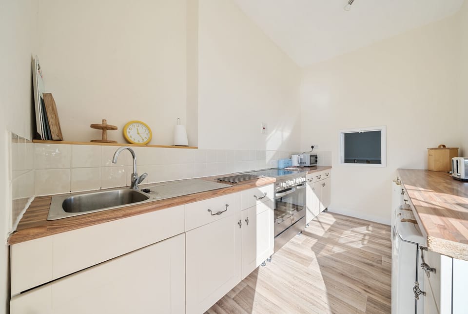 Kitchen with under counter dishwasher and freezer.