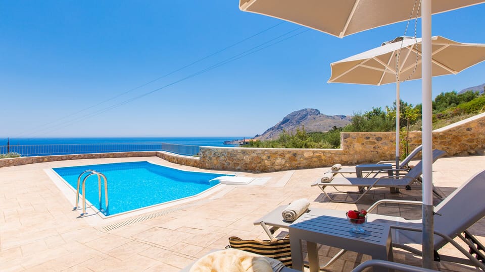 Pool area with sun beds and umbrellas