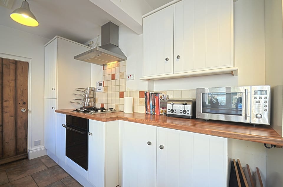 The modern country kitchen has full size fridge/freezer, oven, dishwasher....