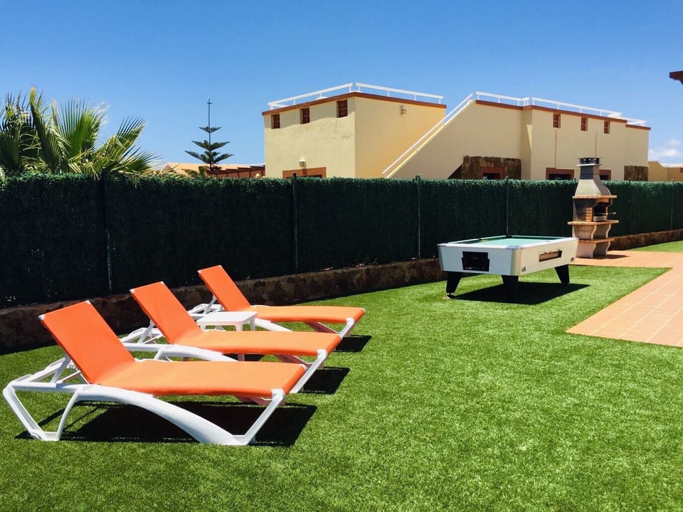 Back garden which overlooks golf course. Sun loungers, pool table and BBQ.