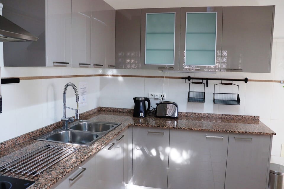 Kitchen with oven, hob, fridge freezer, microwave, dishwasher, washing machine.