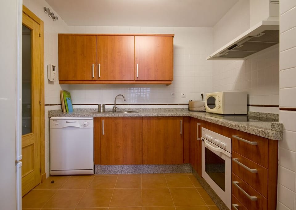 Full kitchen with marble counters, microwave, stove, oven, dishwasher & fridge